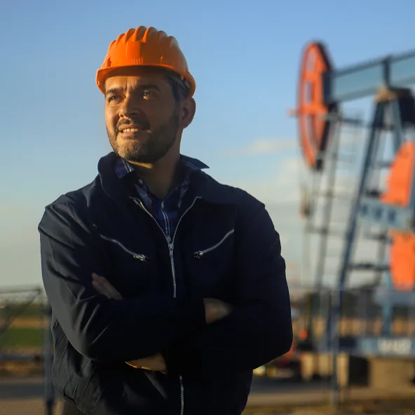 Guy with a orange hat smiling outside